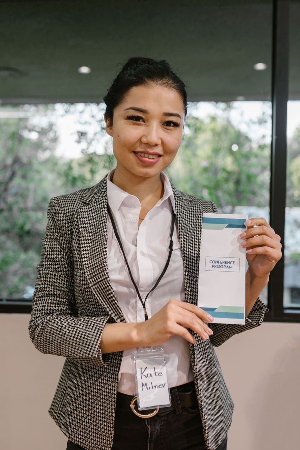 An event organiser holding a conference programme